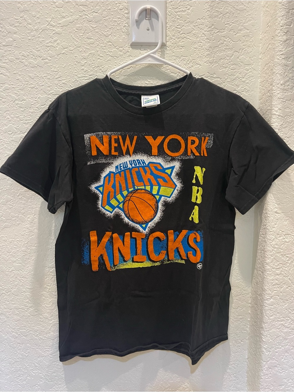 47 Adult Black New York Knicks Graphic Tee with Orange & Blue Logo